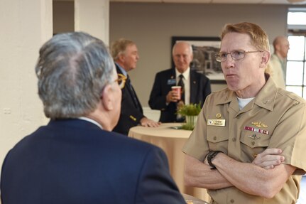 U.S. Navy Capt. Robert Hudson, 628th Air Base Wing deputy commander, right, talks with John Jeffries, Secure Mission Solutions/Parsons contracts director, during the Federal Executive Association of the Greater Charleston Area Holiday Coffee Drop-in at Coast Guard Sector Charleston’s Brass Buckle conference room Dec. 16, 2016. The Federal Executive Association promotes coordination of federal agency programs for maximum public benefit and to foster stronger relationships between the agencies’ management officials.