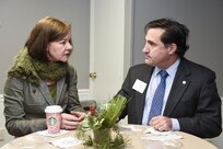 Ched Beam, 628th Air Base Wing executive director, right, speaks to Barbara Neale, South Carolina Department of Health and Environmental Control senior project analyst during the Federal Executive Association of the Greater Charleston Area Holiday Coffee Drop-in at Coast Guard Sector Charleston’s Brass Buckle conference room Dec. 16, 2016. The Federal Executive Association promotes coordination of federal agency programs for maximum public benefit and to foster stronger relationships between the agencies’ management officials.