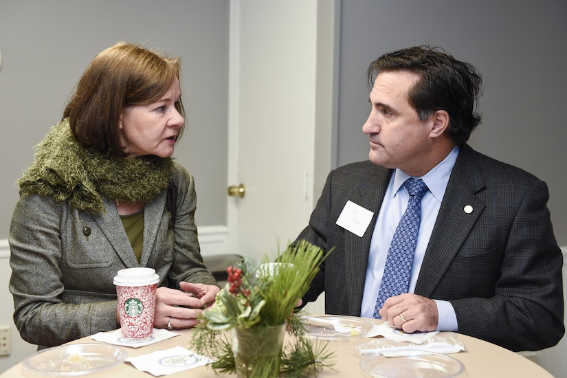 Ched Beam, 628th Air Base Wing executive director, right, speaks to Barbara Neale, South Carolina Department of Health and Environmental Control senior project analyst during the Federal Executive Association of the Greater Charleston Area Holiday Coffee Drop-in at Coast Guard Sector Charleston’s Brass Buckle conference room Dec. 16, 2016. The Federal Executive Association promotes coordination of federal agency programs for maximum public benefit and to foster stronger relationships between the agencies’ management officials.