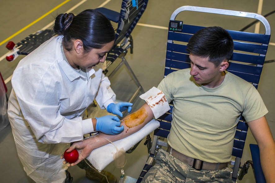 U.S. Army Specialist Dianna McDaniel, medical lab technician, inserts an intravenous line into the arm of Airman 1st Class Shawn Green, 27th Special Operations Civil Engineer Squadron power production technician, during an Armed Forces Blood Program blood drive in bldg. 54’s gym on Nov. 16, 2016, Cannon AFB, N.M. U.S. Army medical personnel traveled from Ft. Bliss, Texas, to a with the blood drive. (U.S. Air Force photo by Senior Airman Luke Kitterman/Released)