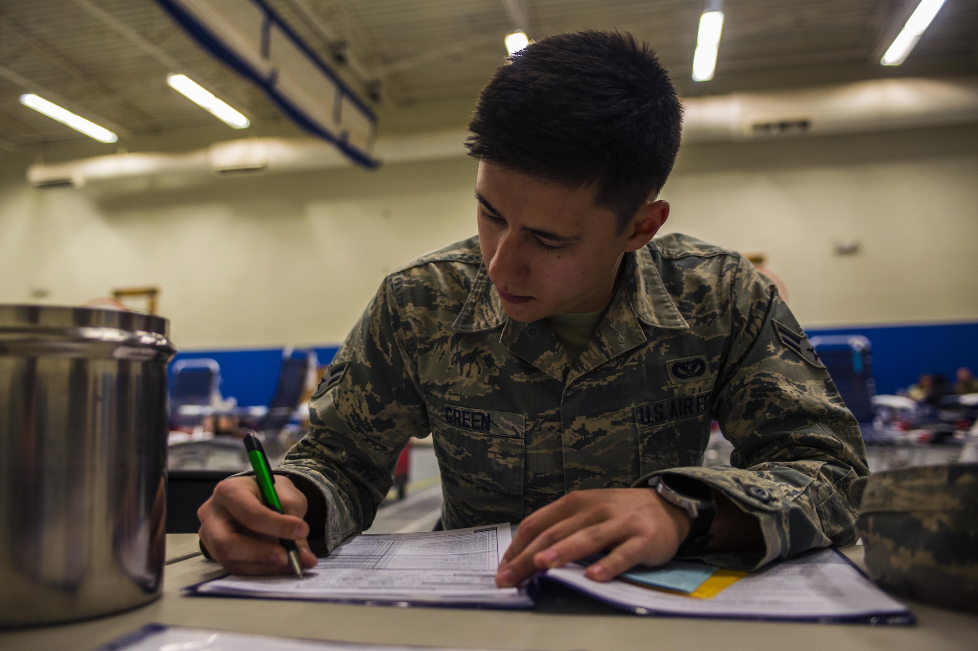 Airman 1st Class Shawn Green, 27th Special Operations Civil Engineer Squadron power production technician, fills out paperwork before donating blood at an Armed Forces Blood Program blood drive in bldg. 54’s gym on Nov. 16, 2016, Cannon AFB, N.M. The ASBP was established more than 60 years ago as a joint field operating agency. (U.S. Air Force photo by Senior Airman Luke Kitterman/Released)