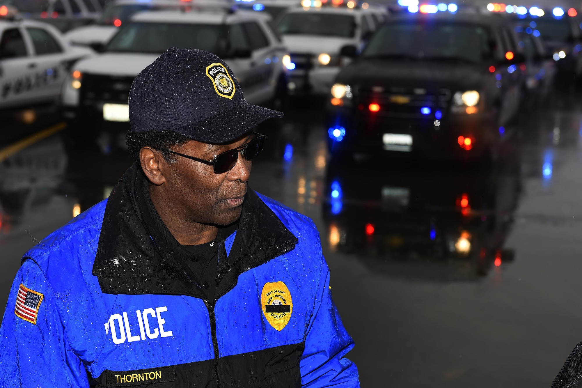 Charles Thornton, Joint Base Lewis-McChord Directorate of Emergency Services joint operations officer for McChord Filed, directs law enforcement officers from all over the country staged on McChord Filed, Wash., Dec 9, 2016, for the funeral of Tacoma Police Officer Reginald “Jake” Gutierrez. Thornton has been involved with police officer funeral proceedings three times in the past. (U.S. Air Force photo/Tech. Sgt. Tim Chacon)