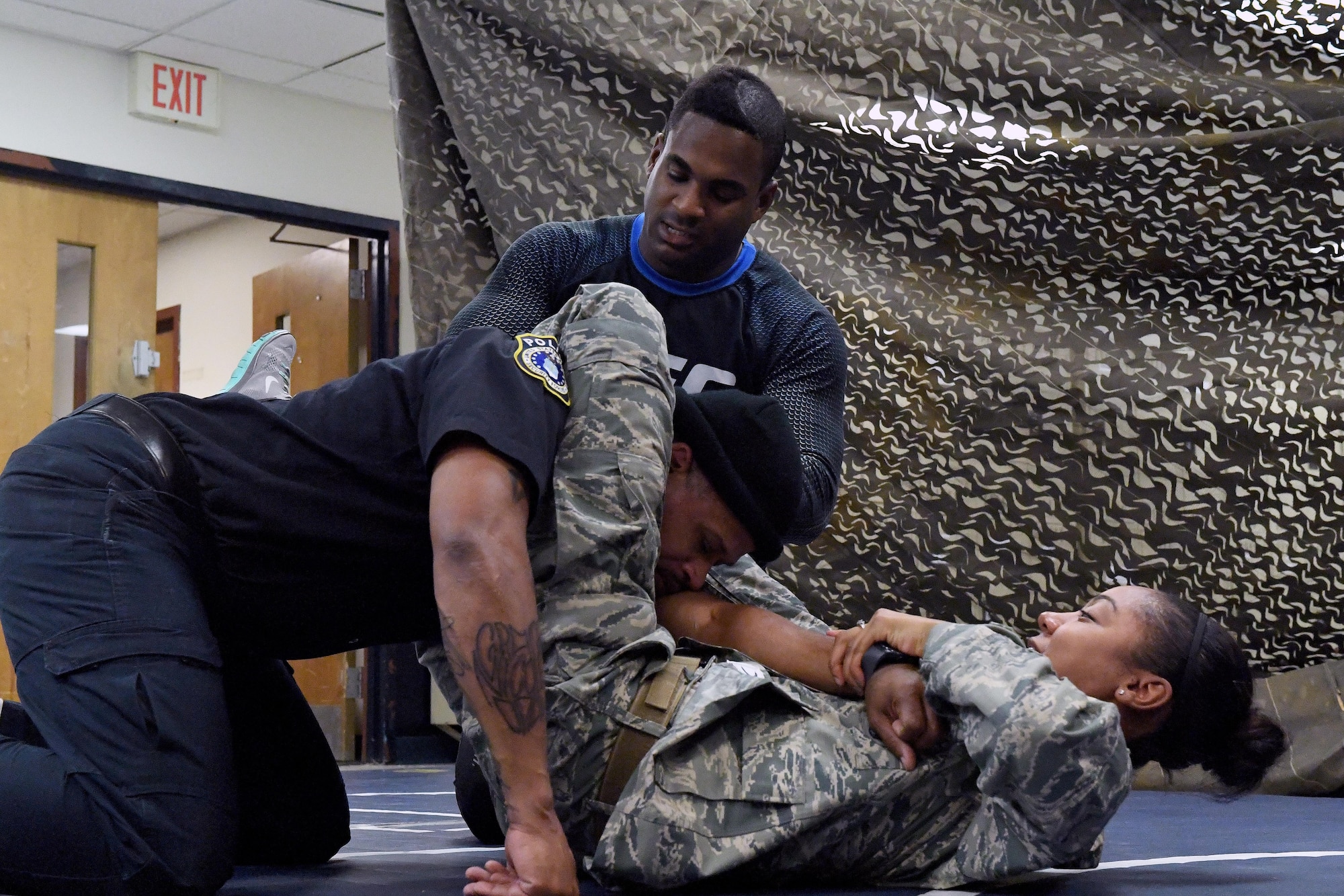 Senior Airman Jexsira Watts, 633rd Security Forces Squadron response force leader, applies a triangle choke on Tony Molette, 633rd SFS law enforcement officer, with assistance from Lorenz Larkin, a professional Ultimate Fighting Championship mixed martial artist, during a combatives course at Joint Base Langley-Eustis, Va., Dec. 8, 2016. Larkin’s appearance was part of a distinguished visitor tour where military members and dependents had an opportunity to meet and get autographs from Shevchenko, other UFC fighters and radio hosts throughout the week. During the tour the UFC athletes spoke with service members about similarities between the UFC and the U.S. Armed Forces. (U.S. Air Force photo by Staff Sgt. Nick Wilson)