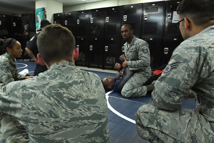Tech. Sgt. Franklin Mosley, 633rd Security Forces flight chief and combatives course instructor, gives a demonstration with Lorenz Larkin, a professional Ultimate Fighting Championship mixed martial artist, on how to execute various grappling techniques from the full mount position during a combatives course at Joint Base Langley-Eustis, Va., Dec. 8, 2016. Larkin spoke to service members about how the mental toughness that is required to become successful and reach goals, whether in the UFC or military. He also toured both of JBLE’s installations alongside a group of mixed-martial arts athletes, journalists and celebrities throughout the week as part of a military appreciation visit. (U.S. Air Force photo by Staff Sgt. Nick Wilson)
