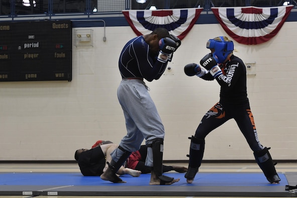 Tech. Sgt. Franklin Mosley, the 633rd Security Forces flight chief and a combatives course instructor, braces for a punch during a sparring session with Valentina Shevchenko, an Ultimate Fighting Championship muay thai specialist, at Joint Base Langley-Eustis, Va., Dec. 9, 2016. Shevchenko visited as part of a morale tour and used her free time between events to train for an upcoming match. Although she is new to the UFC with a record of 2-1, she has a professional kickboxing record in Kyrgyzstan of 58-2. (U.S. Air Force photo/Staff Sgt. Nick Wilson)