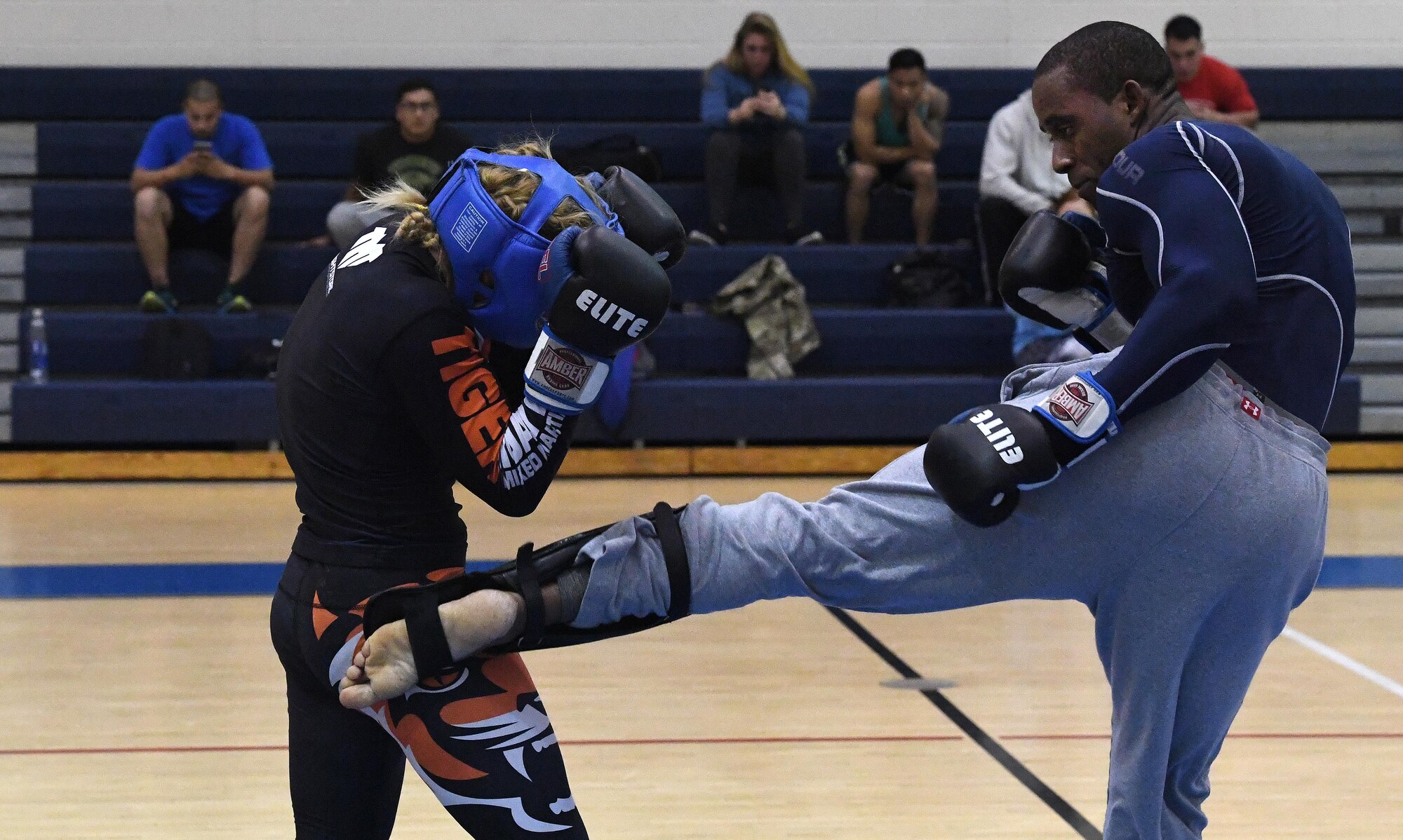Tech. Sgt. Franklin Mosley, 633rd Security Forces flight chief and combatives course instructor, kicks Valentina Shevchenko, an Ultimate Fighting Championship Muay Thai specialist, during a training session at Joint Base Langley-Eustis, Va., Dec. 9, 2016. Shevchenko visited JBLE as part of a morale tour and used her free time between events to train for an upcoming match. She is also a professional kickboxer from Kyrgyzstan, who began her professional career when she was 12 years old, when she knocked out a 22-year-old opponent, earning the nickname “Bullet.” (U.S. Air Force photo by Staff Sgt. Nick Wilson)
