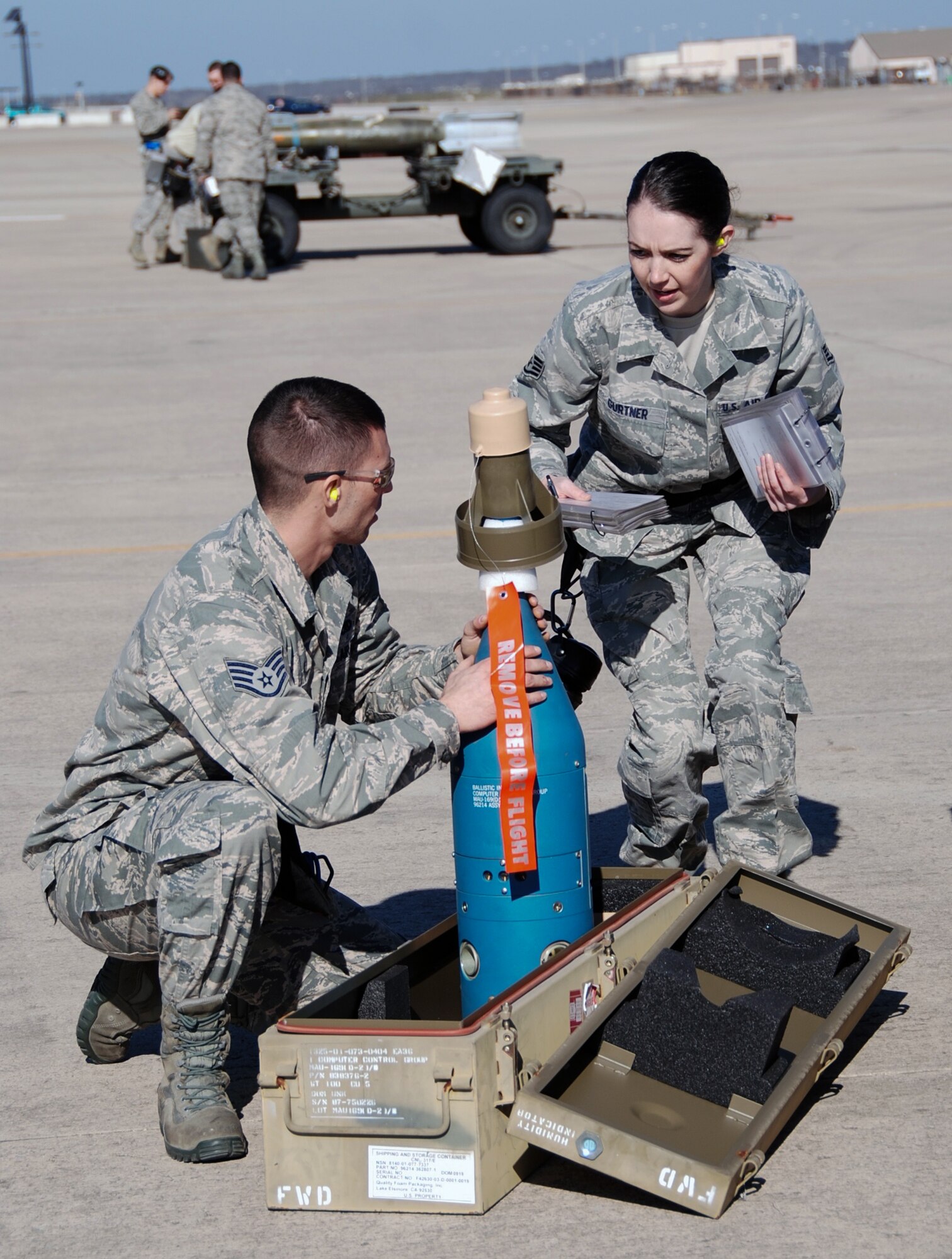 Staff Sgt. Kaisha Gurtner and Staff Sgt. Luke Hatton, assigned to the 301st Aircraft Maintenance Squadron here, prepare the guidance control unit of an inert laser guided munition Feb. 8, 2015, during the wing's weapons load competition. Working side-by-side, active duty and Reserve Airmen towed, placed, and properly loaded four inert munitions onto each of the four F-16 Fighting Falcons in under 47 minutes. (U.S. Air Force photo/Staff Sgt. Melissa Harvey)