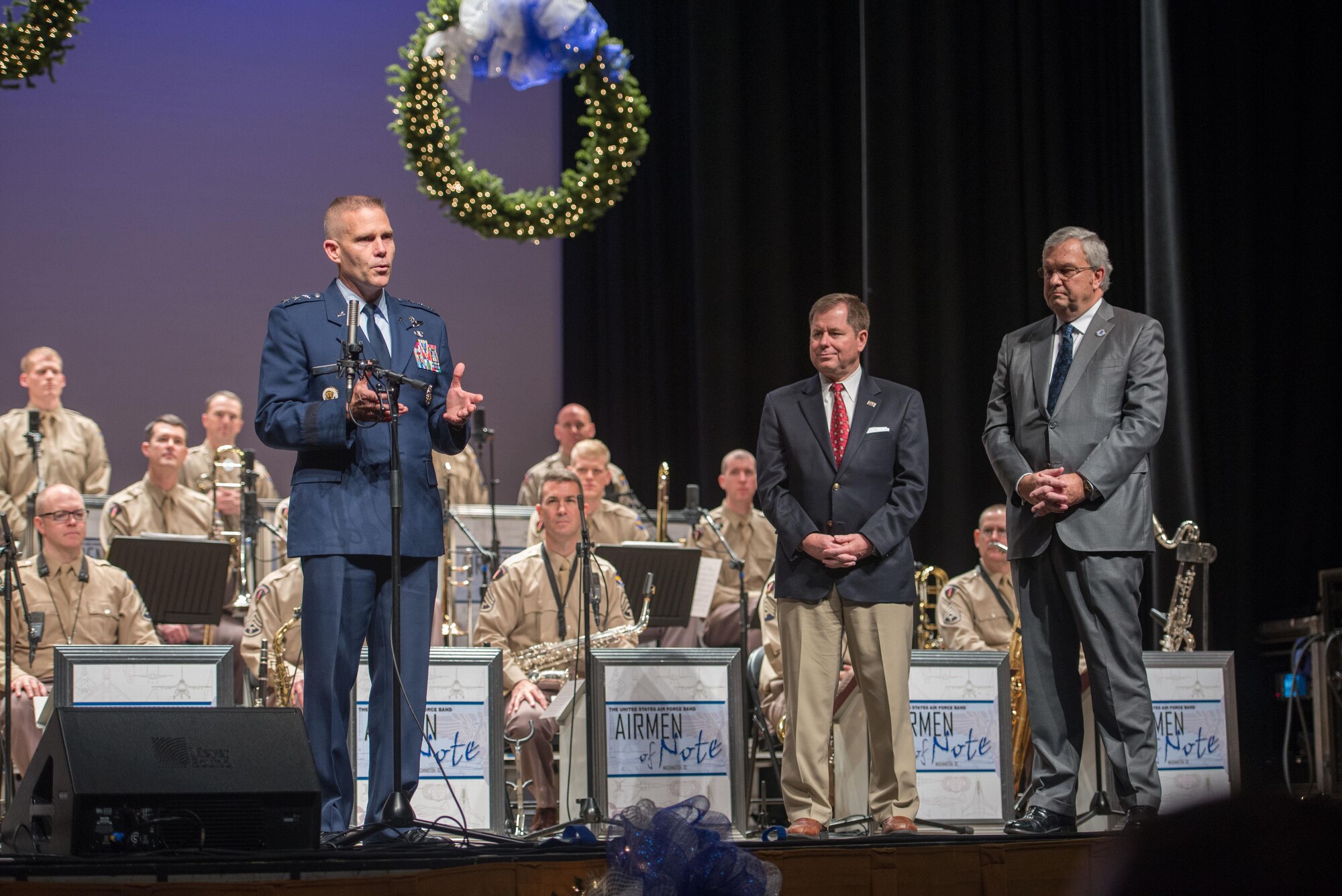 Air University Commander Lt. Gen. Steven Kwast addresses a packed house at Troy University’s Davis Theater in Downtown Montgomery, Ala. Dec. 14, 2016. Airmen of Note, the U.S. Air Force’s premier jazz ensemble, traveled to Montgomery to give a concert in its signature Glenn Miller style. The limited tickets were free, but concert goers were asked to donate non-perishable food at the show. By show’s end, 463 pounds were collected and donated to the Montgomery Area Foodbank. Accompanying Kwast, left to right, are Troy University Vice Chancellor Lance and Montgomery Director of Public Safety J. Christopher Murphy. (U.S. Air Force photo/Trey Ward) 