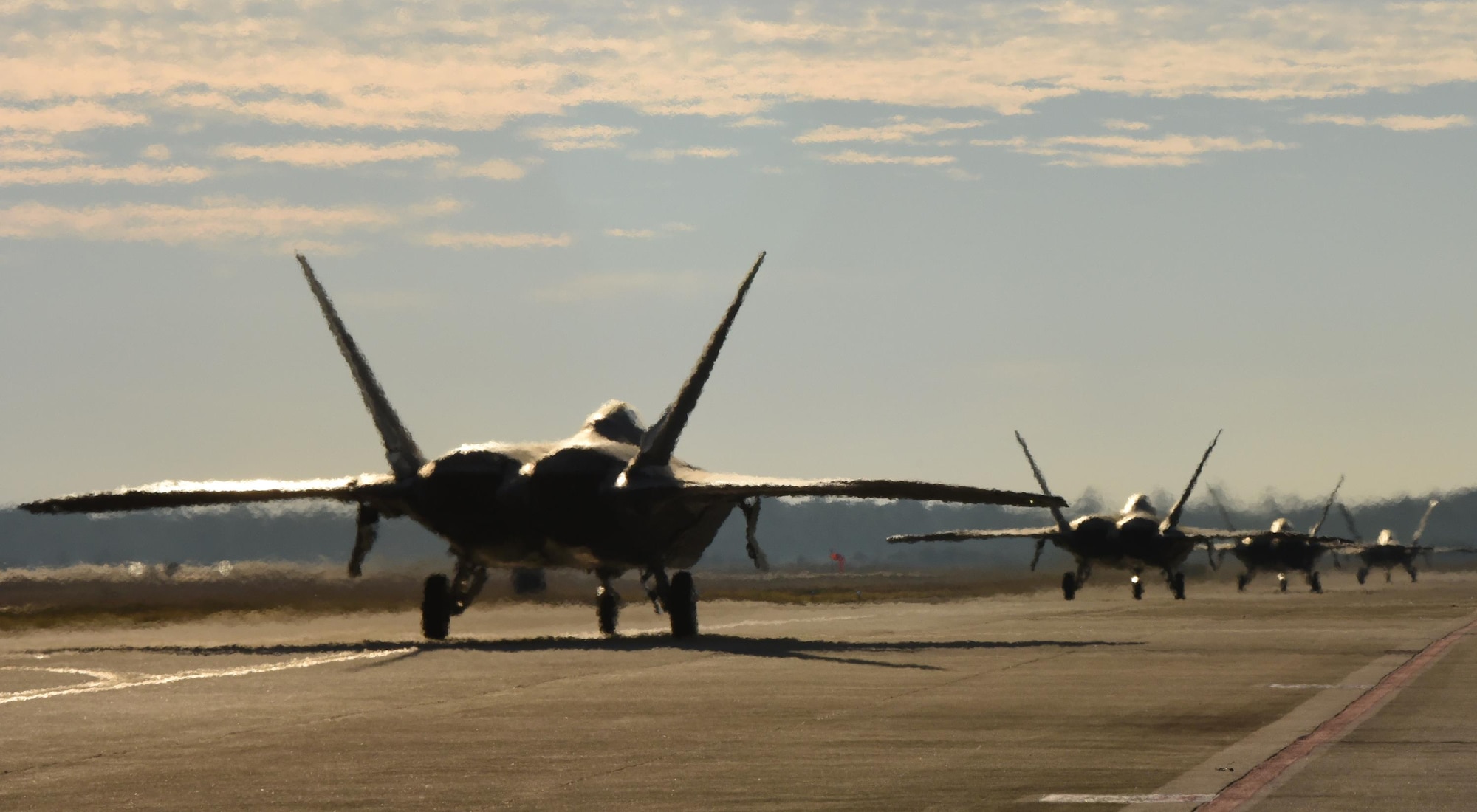 Four U.S. Air Force F-22 Raptors from Tyndall Air Force Base, Fla., taxi down Tyndall’s flightline during Checkered Flag 17-1, Dec. 8, 2016. During the exercise, the units involved are evaluated on their ability to mobilize, integrate, deploy and employ combat air power assets on a large scale. (U.S. Air Force photo by Staff Sergeant Alex Fox Echols III/Released)