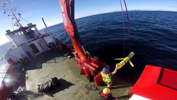 Crew members aboard the VOS Raasay recover U.S. and British Royal Navy ocean gliders taking part in the Unmanned Warrior exercise off the northwest coast of Scotland, Oct. 8, 2016. A similar unmanned underwater vehicle was seized by the Chinese Navy in international waters off the coast of the Philippines Dec. 15. Screen shot via navylive.dodlive.mil