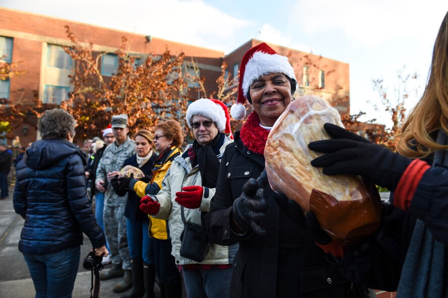 Mary Moss, Lakewood City Council member, civic leaders and 62nd Airlift Wing leadership participate in Operation Ham Grenade on Joint Base Lewis-McChord, Wash. Dec. 16, 2016. More than two-hundred hams were delivered to the 62nd AW, to be distributed out to Airmen for the December holidays. (U.S. Air Force photo/Staff Sgt. Naomi Shipley)