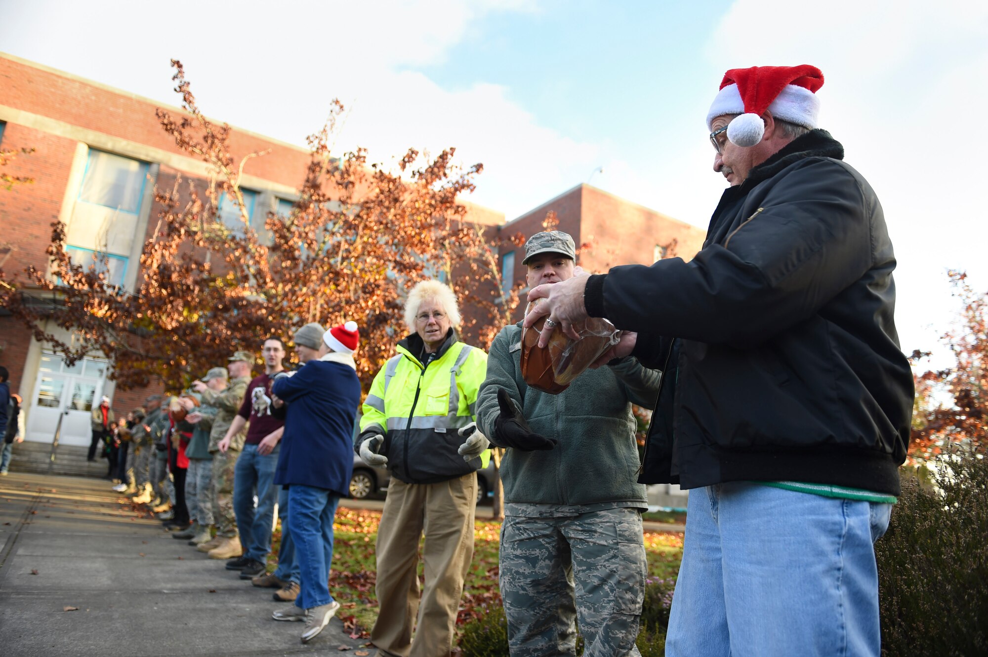 Local community leaders and 62nd Airlift Wing members participate in Operation Ham Grenade on Joint Base Lewis-McChord, Wash. Dec. 16, 2016. This event allows for Airmen and Soldiers at JBLM to take home a ham at no cost to the member. (U.S. Air Force photo/Staff Sgt. Naomi Shipley)