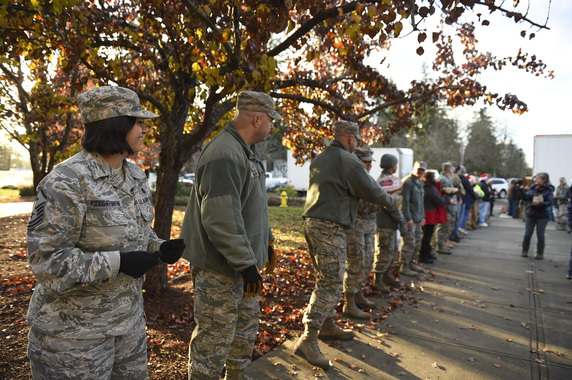 Members of the 62nd Airlift Wing participate in Operation Ham Grenade on Joint Base Lewis-McChord, Wash. Dec. 16, 2016. More than 500 hams were distributed to Airmen and Soldiers at JBLM in total for the December holidays. (U.S. Air Force photo/Staff Sgt. Naomi Shipley)