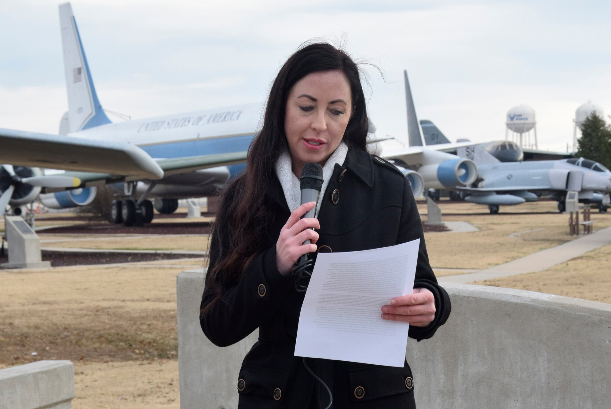 Amber Skelton, the great niece of Staff Sgt. Alvis Tinsley, talks about her uncle and the experience of visiting his grave at Ardennes American Cemetery in Belgium. “One of my favorite quotes displayed at the cemetery is ‘To the silent host who endured all and gave all that mankind might live in freedom and in peace,’” said Ms. Skelton. “We are very honored and proud to accept this flag on his behalf.”  (Air Force photo by Kimberly Woodruff)