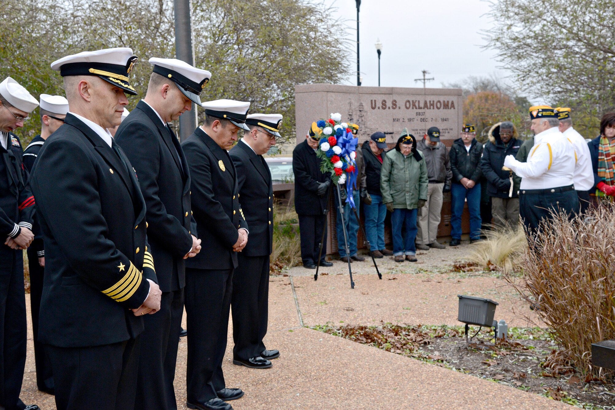 More than 50 Sailors from Strategic Communications Wing ONE, including Capt. Ed McCabe, commander of SCW-1 and Task Force 124, left, and veterans from the Fleet Reserve Association USS Oklahoma (BB-37) Memorial Branch 268 paid respect to the more than 2,400 fallen Sailors and Marines at Pearl Harbor 75 years ago. This Pearl Harbor Day ceremony was held Dec. 7 at the Veteran’s Memorial near the Oklahoma State Capitol. (Air Force photo by Kelly White)