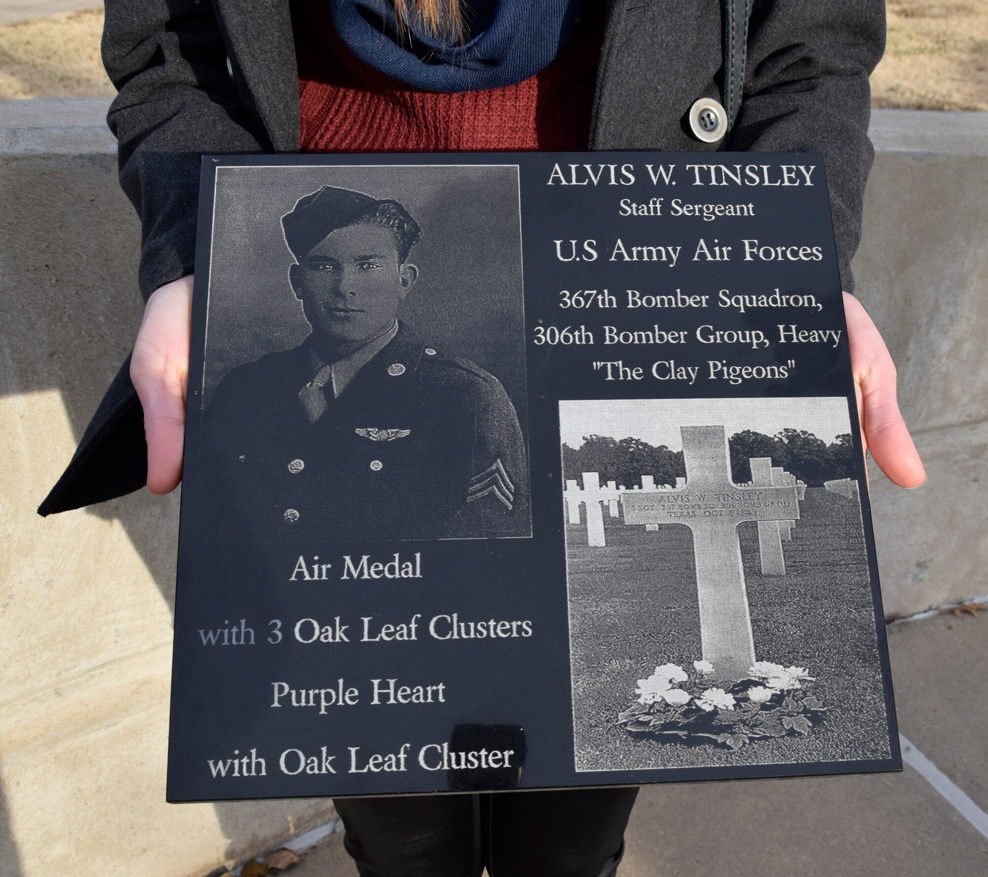 A plaque with the photo of Staff Sgt. Alvis Tinsley and his gravesite at Ardennes American Cemetery, Belgium. (Air Force photo by Kimberly Woodruff)