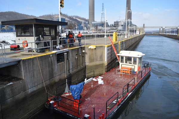 A workboat rests on the main chamber lock wall as repair crews above work to fix New Cumberland Locks and Dam's hydraulic system. 
