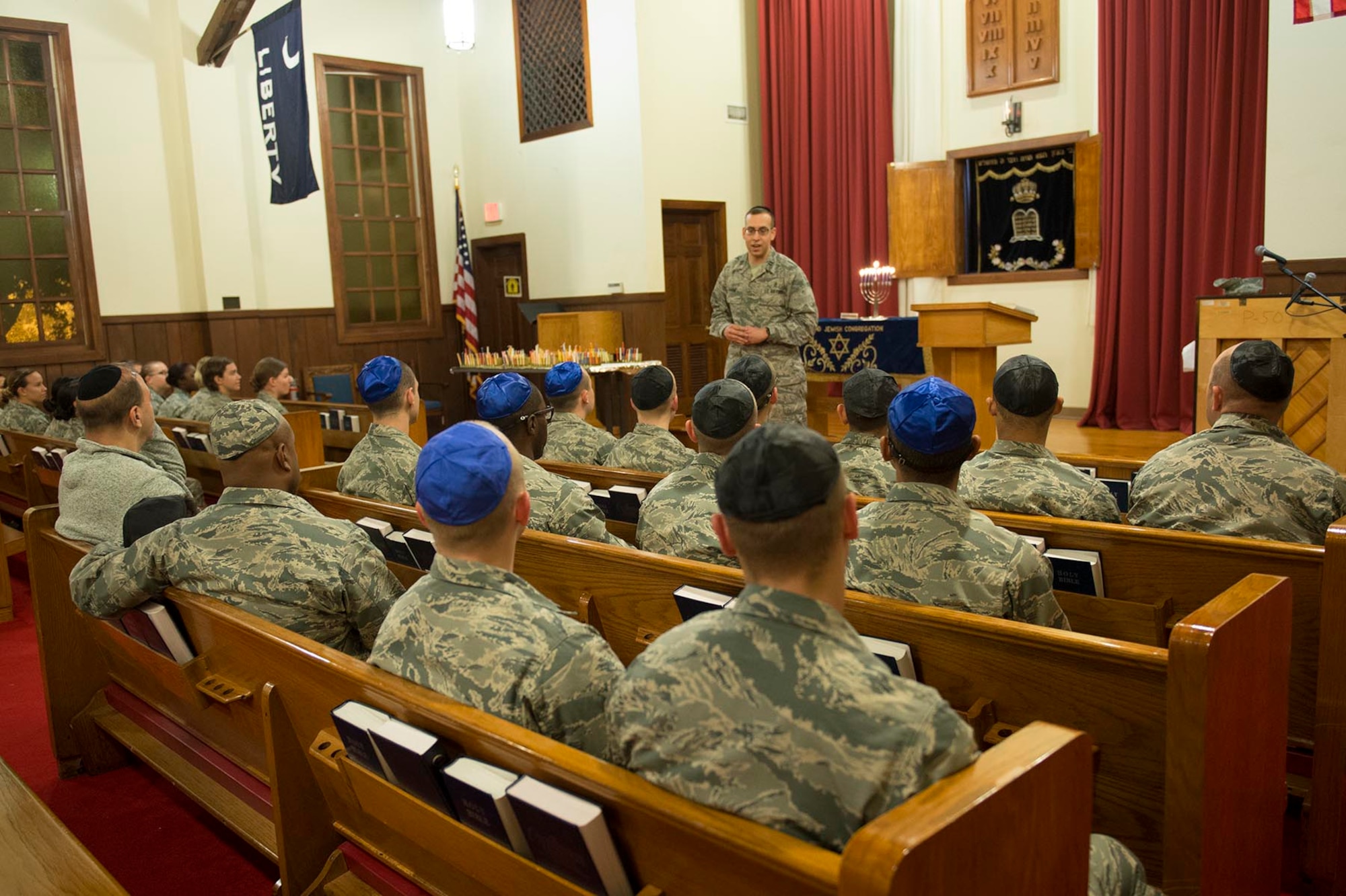 Chaplain Kahan, 502nd Air Base Wing Jewish chaplain, speaks to the congregation Dec. 13, 2015. The 502nd Air Base Wing Chaplain’s Office gives Airmen in basic training and technical school the opportunity to attend the traditional ceremony and enjoy traditional Hanukkah refreshments and activities afterward. Hanukkah, which is celebrated this year from sundown Dec. 24 to sundown Jan. 1, is known as the Festival of Lights. (Courtesy Photo)