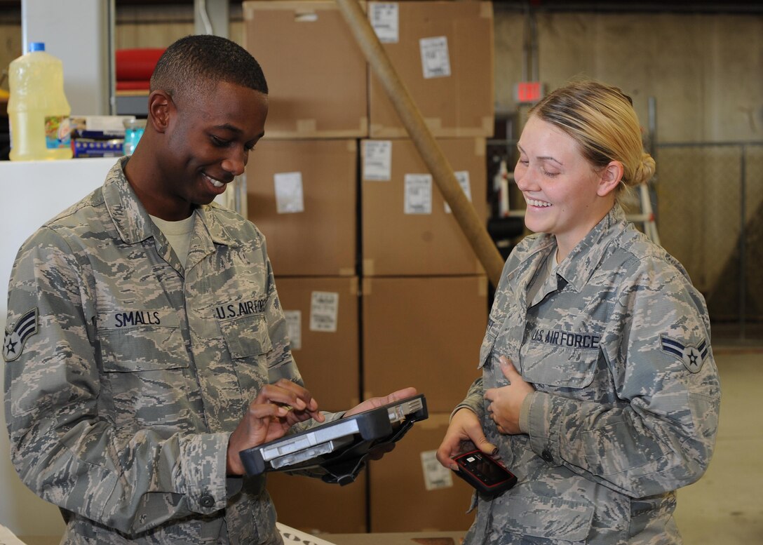 U.S. Air Force Senior Airman Trevien Smalls, 355th Equipment Maintenance Squadron material management, signs for a delivery from Airman 1st Class Katherine Street, 355th Logistics Readiness Squadron vehicle operator, at Davis-Monthan Air Force Base, Ariz., Dec. 14, 2016. The use of new Wi-Fi hot spots are making signing for deliveries smoother and more efficient, saving man-hours in both the 355th LRS and receiving units. (U.S. Air Force photo by Senior Airman Ashley N. Steffen)