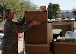U.S. Air Force Airman 1st Class Katherine Street, 355th Logistics Readiness Squadron vehicle operator, receives packages for delivery at Davis-Monthan Air Force Base, Ariz., Dec. 14, 2016. Once supplies are delivered to the installation, LRS distributes them to individual units across the base allowing supplies to be readily available. (U.S. Air Force photo by Senior Airman Ashley N. Steffen)