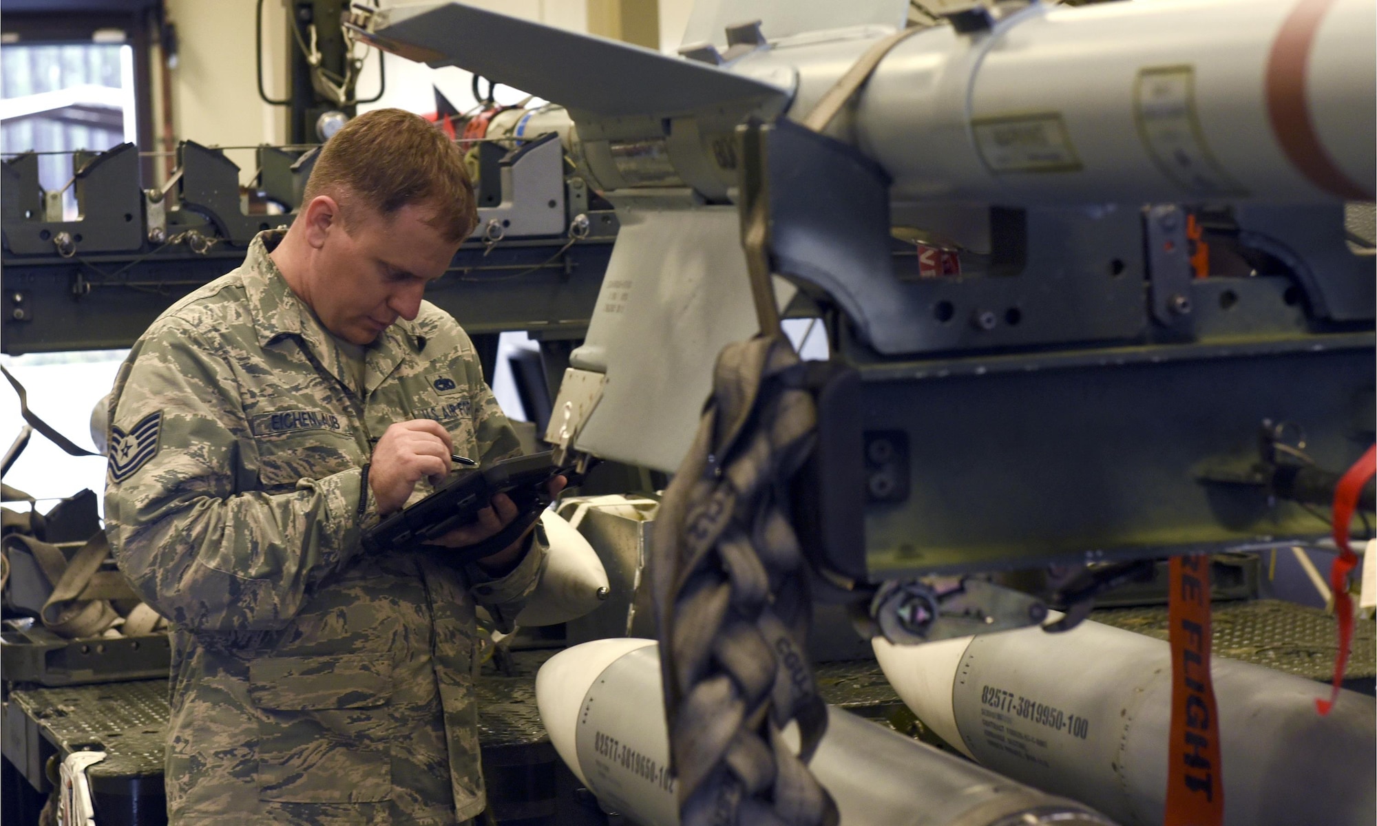 U.S. Air Force Tech. Sgt. Richard Eichenlaub, 325th Maintenance Squadron munitions systems specialist, performs an accountability check of ordnance on a weapons rack at Tyndall Air Force Base, Fla., Dec. 14, 2016. The 325th Fighter Wing houses an arsenal of some of the most advanced weapons in the world as a base with fifth-generation fighters. The responsibility of munitions systems specialists is to assemble and process these powerful non-nuclear munitions. (U.S. Air Force photo by Airman 1st Class Cody R. Miller/Released)
