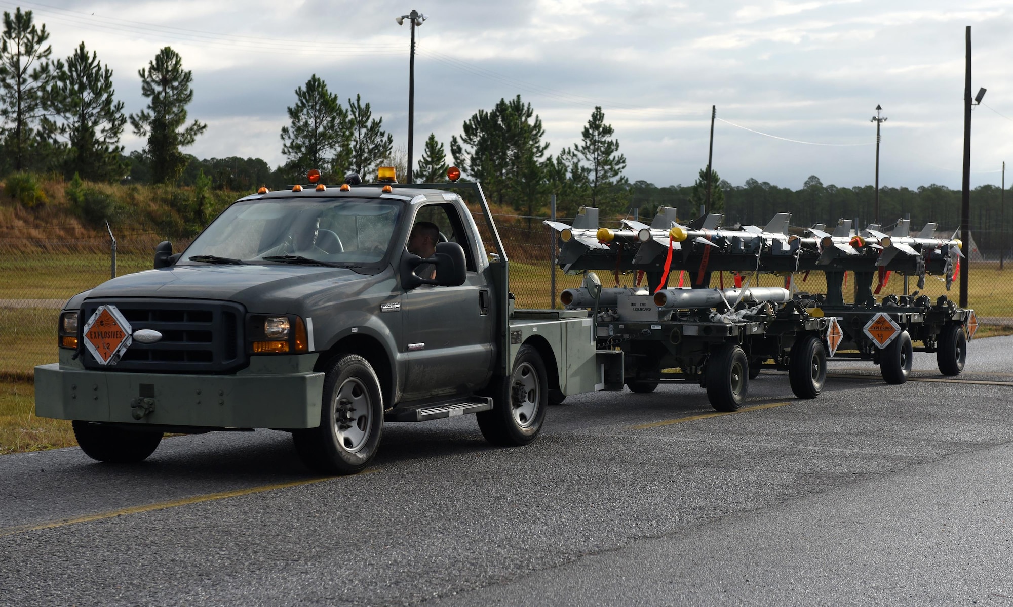 Munitions systems specialist transport weapons systems racks to the flightline during Checkered Flag 17-1 and Combat Archer 17-3, two exercises that ran concurrently at Tyndall Air Force Base, Fla., Dec. 14, 2016. Exercises such as Checkered Flag and Combat Archer are meant to evaluate the performance of coordinating fifth-generation and legacy fighters during large-scale engagements. (U.S. Air Force photo by Airman 1st Class Cody R. Miller/Released)