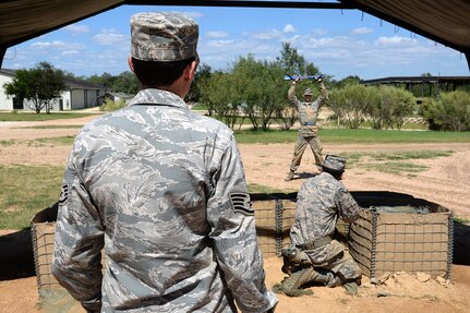 Staff Sgt. Britney Simpson (left), 319th Training Squadron military training instructor, directs trainees on proper escalation of force procedures during a training exercise Sept. 28 at the Joint Base San Antonio-Lackland
Medina Annex. (U.S. Air Force photo by Staff Sgt. Marissa Garner)
