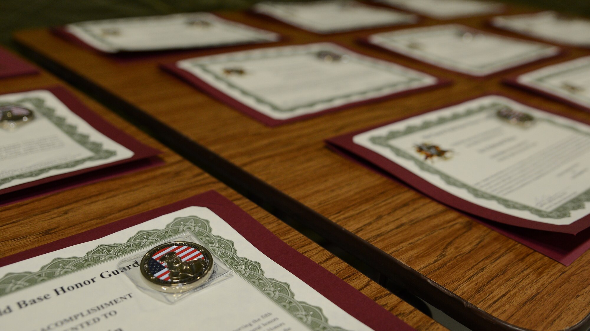 McChord Base Honor Guard graduation certificates are displayed during a change or responsibility ceremony Dec. 13, 2016, at Joint Base Lewis-McChord, Wash. The certificates were given to the graduating flight for completing a two week honor guard training course. (U.S. Air Force photo/Senior Airman Jacob Jimenez)    