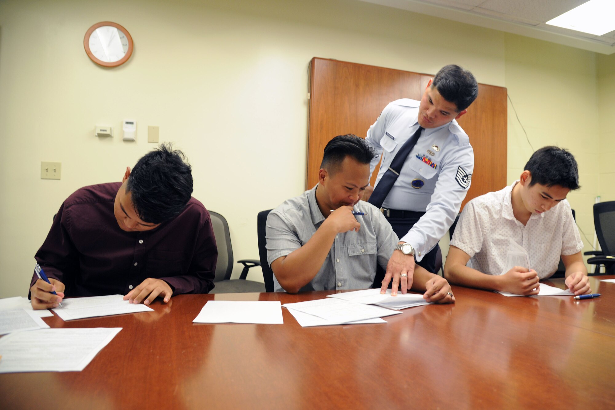 U.S. Air Force Tech. Sgt. Michael Shinohara, an Air Force Reserve recruiter based out of Joint Base Pearl Harbor-Hickam, Hawaii, explains the enlistment contract to Mark Corpuz, of Ewa Beach, who is joining the 624th Aeromedical Staging Squadron as a medical admin, at JBPH-H, Nov. 30, 2016. The 624th ASTS supports the 624th Regional Support Group's mission to deliver mission essential capability through combat readiness, quality management and peacetime deployments in the Pacific area of responsibility. (U.S. Air Force photo by Master Sgt. Theanne Herrmann)