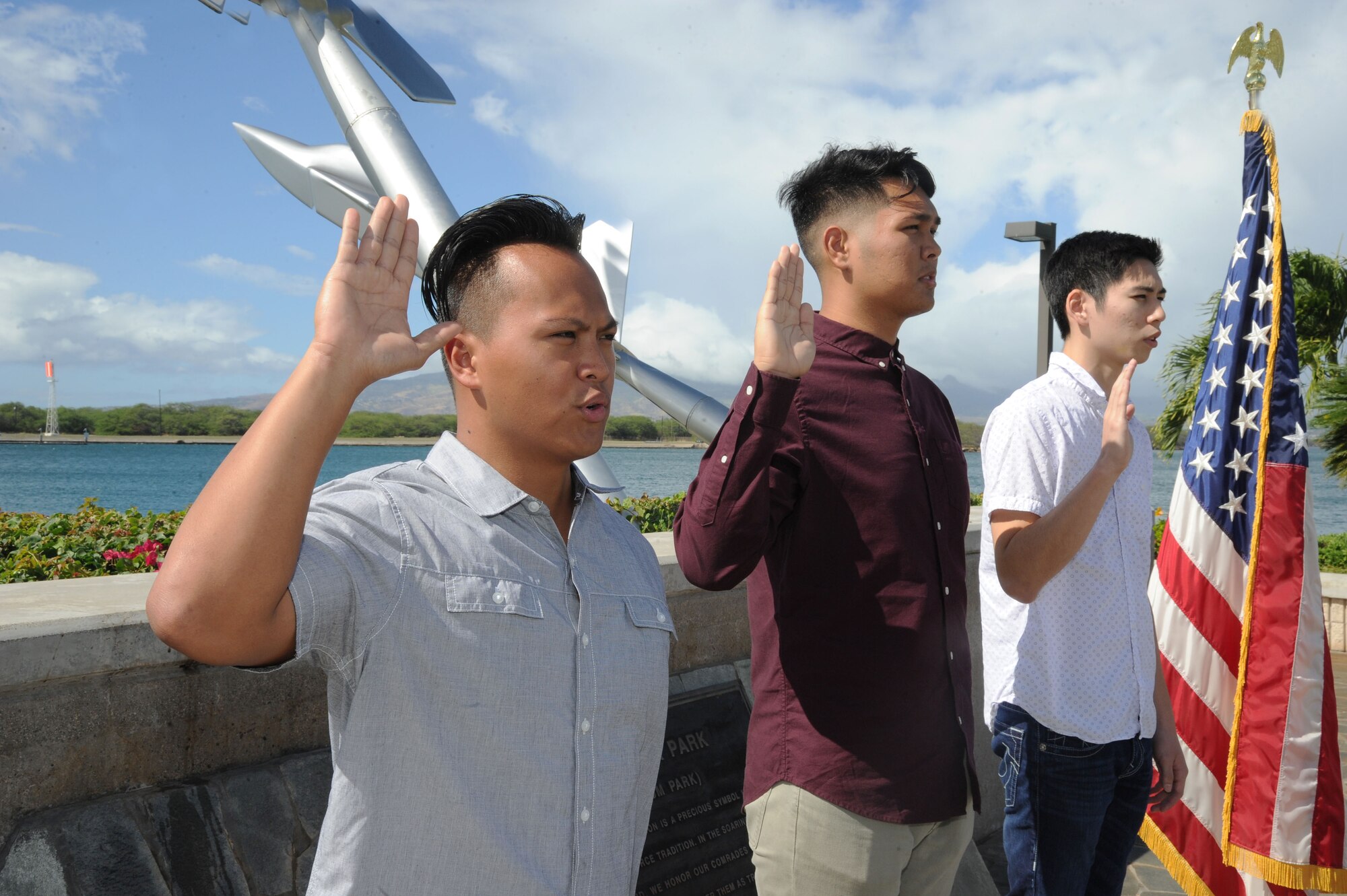 Three recruits take their oath of enlistment at the Missing Man Formation to join the Air Force Reserve's 624th Regional Support Group based out of Joint Base Pearl Harbor-Hickam, Hawaii, Nov. 30, 2016. Left to right: Mark Corpuz, of Ewa Beach, joining the 624th Aeromedical Staging Squadron as a medical admin; Allan Lai, of Honolulu, and Bryson Primacio, of Kapolei, are joining the 48th Aerial Port Squadron as Air Transportation specialists. The 624th ASTS and the 48th APS support the 624th Regional Support Group's mission to deliver mission essential capability through combat readiness, quality management and peacetime deployments in the Pacific area of responsibility. (U.S. Air Force photo by Master Sgt. Theanne Herrmann) 