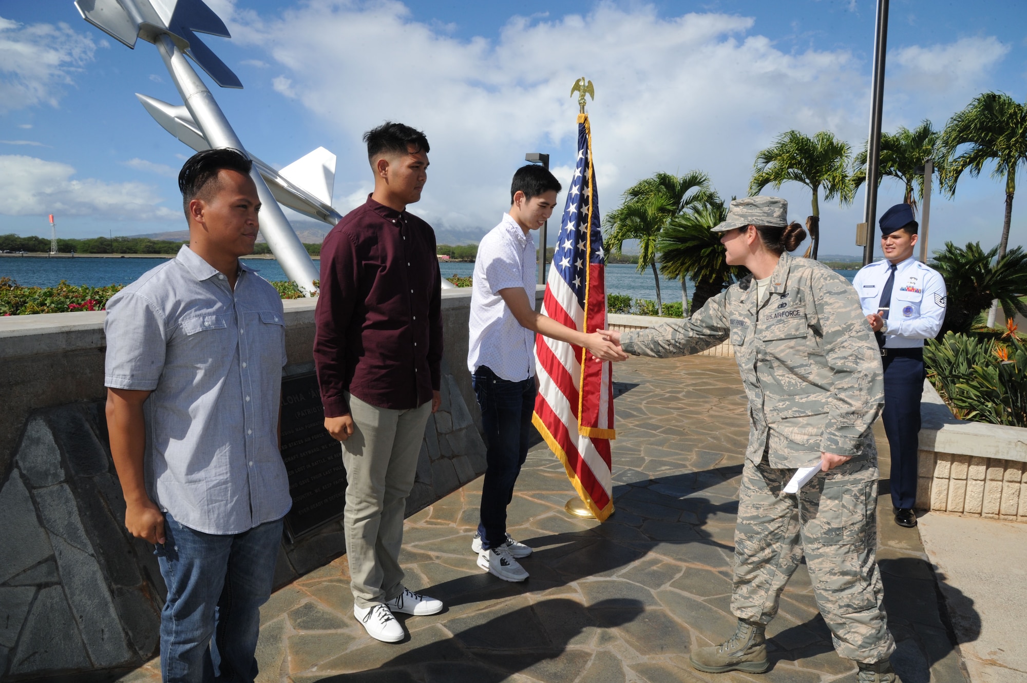 U.S. Air Force 2nd Lt. Elizabeth Andreas-Feeney, a member of the Air Force Reserve's 624th Regional Support Group, congratulates Allan Lai, of Honolulu, for enlisting in the Air Force Reserve at Joint Base Pearl Harbor-Hickam, Hawaii, Nov. 30, 2016. Left to right: Mark Corpuz, of Ewa Beach, will be joining the 624th Aeromedical Staging Squadron as a medical admin, and Bryson Primacio, of Kapolei, is joining the 48th Aerial Port Squadron as Air Transportation specialists. The 624th ASTS and the 48th APS support the 624th Regional Support Group's mission to deliver mission essential capability through combat readiness, quality management and peacetime deployments in the Pacific area of responsibility. (U.S. Air Force photo by Master Sgt. Theanne Herrmann)