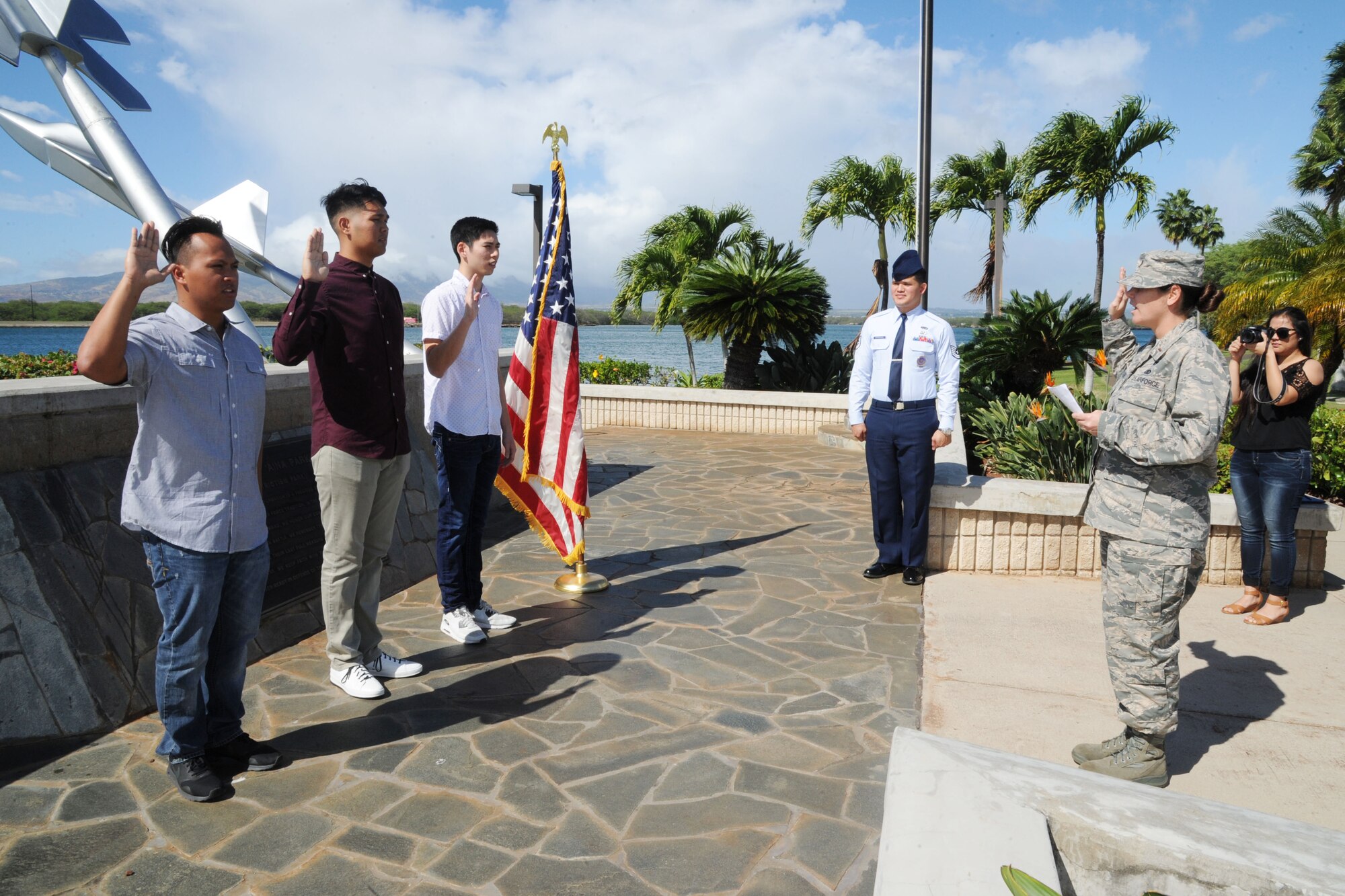U.S. Air Force 2nd Lt. Elizabeth Andreas-Feeney, a member of the Air Force Reserve's 624th Regional Support Group, conducts the oath of enlistment for three new recruits at the Missing Man Formation at Joint Base Pearl Harbor-Hickam, Hawaii, Nov. 30, 2016. Left to right: Mark Corpuz, of Ewa Beach, who is joining the 624th Aeromedical Staging Squadron, Allan Lai, of Honolulu, and Bryson Primacio, of Kapolei, are joining the 48th Aerial Port Squadron. The 624th ASTS and the 48th APS support the 624th Regional Support Group's mission to deliver mission essential capability through combat readiness, quality management and peacetime deployments in the Pacific area of responsibility. (U.S. Air Force photo by Master Sgt. Theanne Herrmann)