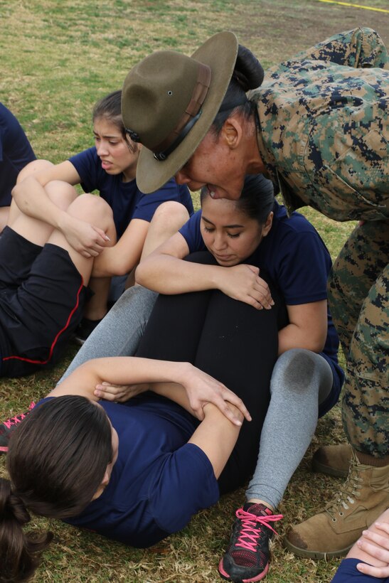 Drill Instructor Sgt. Jasmine James encourages future Marines to conduct crunches within the two minutes their allotted in order to pass the crunch portion of the Initial Strength Test during a female future Marine function for Recruiting Station Los Angeles at Sherman Oaks Recreation Park, Dec. 10, 2016. (U.S. Marine Corps photo by Staff Sgt. Alicia R. Leaders/Released)