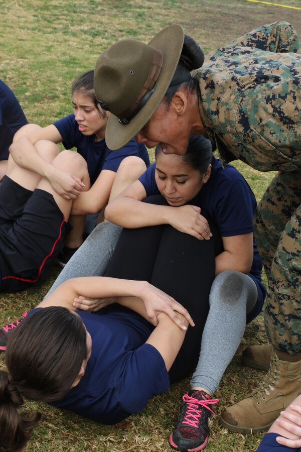 Drill Instructor Sgt. Jasmine James encourages future Marines to conduct crunches within the two minutes their allotted in order to pass the crunch portion of the Initial Strength Test during a female future Marine function for Recruiting Station Los Angeles at Sherman Oaks Recreation Park, Dec. 10, 2016. (U.S. Marine Corps photo by Staff Sgt. Alicia R. Leaders/Released)