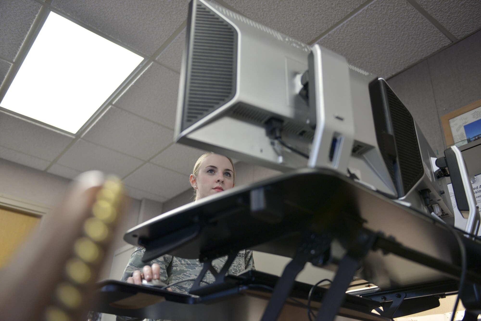 U.S. Air Force Senior Airman Sadie Lambert, a 354th Contracting Squadron contract specialist, reviews a contract Nov. 22, 2016, at Eielson Air Force Base, Alaska. Lambert helps the entire base purchase equipment through contracts. (U.S. Air Force photo by Airman Isaac Johnson)