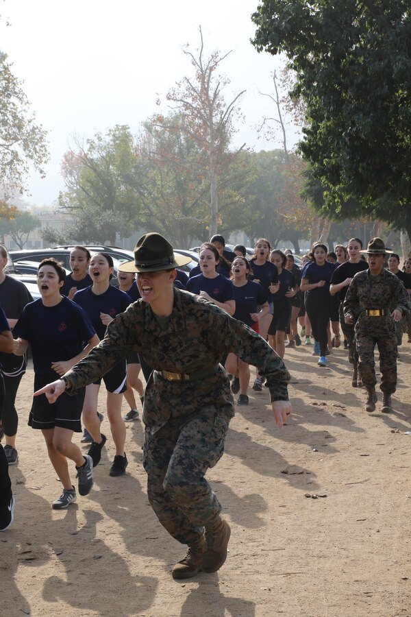 Drill Instructor Staff Sgt. Mallory R. Ortiz commands future Marines to tighten the formation of a motivational run during a female future Marine function for Recruiting Station Los Angeles at Sherman Oaks Recreation Park, Dec. 10, 2016. (U.S. Marine Corps photo by Staff Sgt. Alicia R. Leaders/Released)