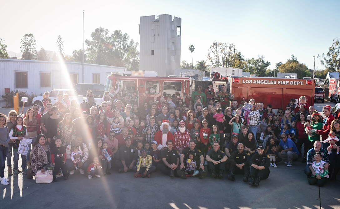 Marines and their families from Recruiting Station Los Angeles gather for a photo with firefighters during Recruiting Station Los Angeles’ Christmas party at the Los Angeles Fire Department Station 88 in Sherman Oaks, Calif., Dec. 3, 2016. Marines and their families gathered, sporting their ugly sweaters and enjoying holiday festivities as a unit. (Photo by Arlene Ward/Released)