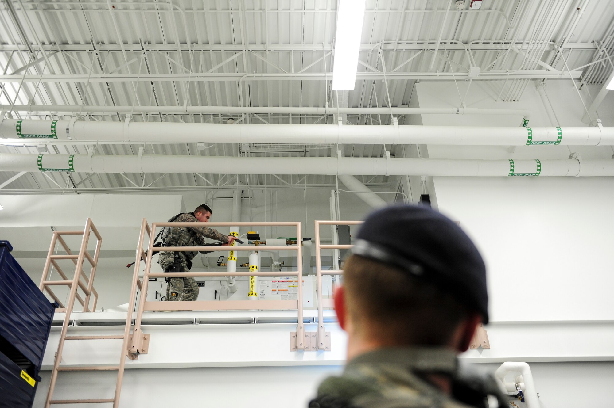 U.S. Air Force Senior Airman Karl McCarthy, a 354th Security Forces Squadron response force leader, checks to make sure an area is clear during active shooter training Dec. 14, 2016, at the 168th Logistics Readiness Squadron building on Eielson Air Force Base, Alaska. During the exercise, Airmen implemented the same process they normally practice in training, but in a foreign environment. (U.S. Air Force photo by Airman Isaac Johnson)