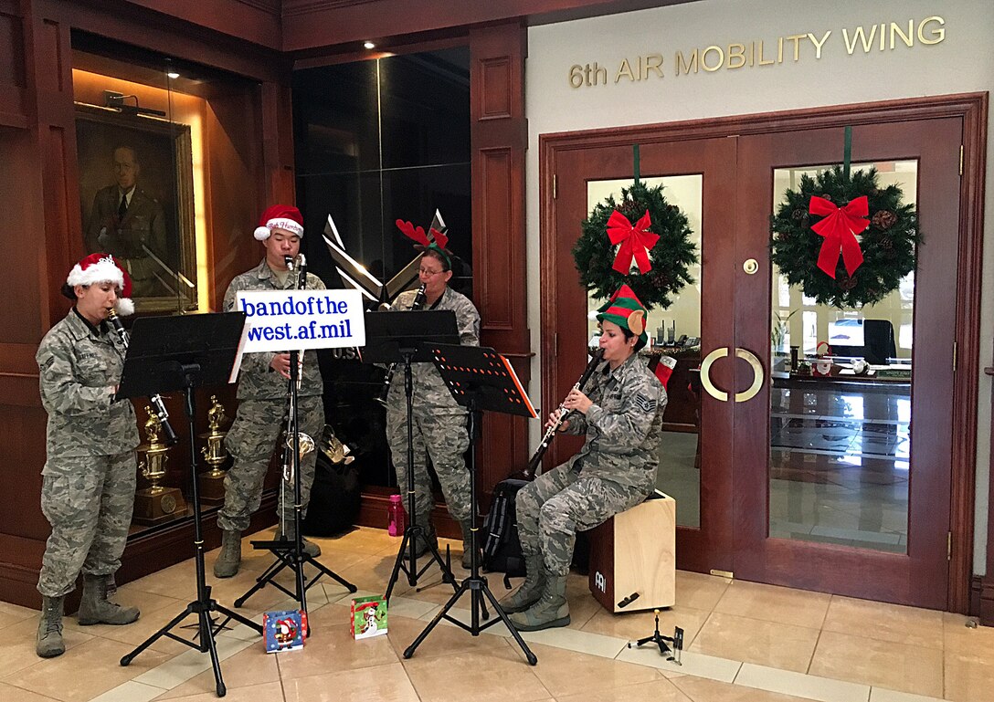 The Band of the West clarinet quartet, the Mission Winds, plays holiday music at the 6th Air Mobility Wing headquarters building during their visit at MacDill Air Force Base, Fla., Dec. 14, 2016. The Mission Winds visited several units around MacDill with the hopes of spreading holiday cheer. (U.S. Air Force photo by Staff Sgt. Brittany Liddon)