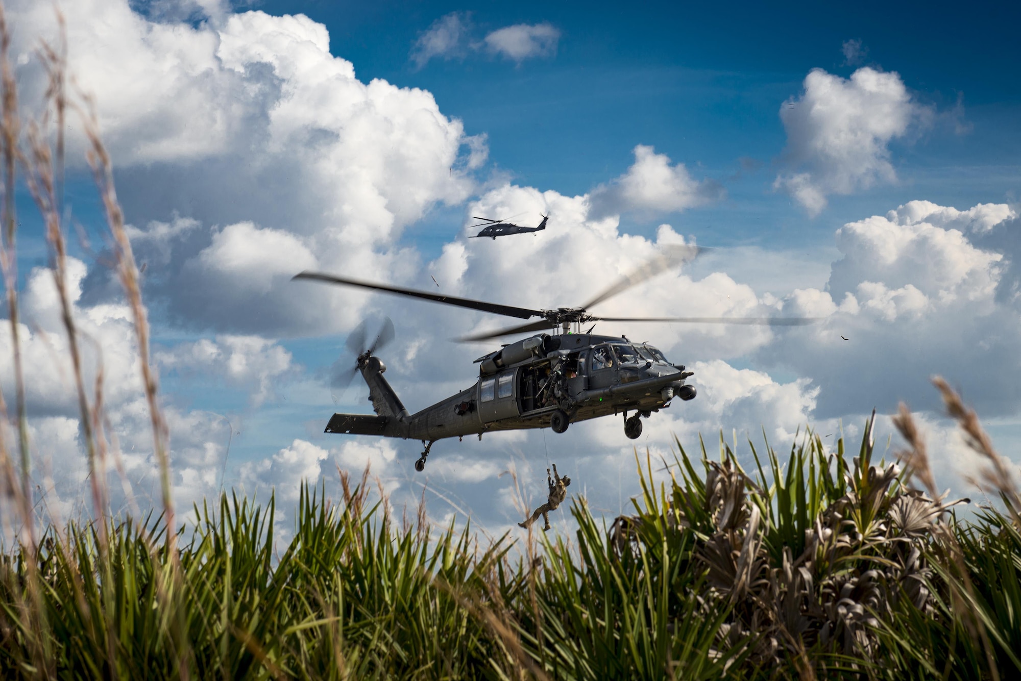 A pararescueman from the 38th Rescue Squadron rides a hoist back into a 41st RQS HH-60G Pave Hawk during a ‘spin-up’ exercise, Dec. 13, 2016, at Avon Park Air Force Range, Florida. Avon Park AFR serves as an air and ground training complex for the military. To mitigate the risk of an uncontrolled wildfire during times of drought, the Avon Park Wildland Support Module works year round employing prescribed burns and other wildland management tools. The WSM is part of the Air Force Wildland Fire Center, a mission of the Air Force Civil Engineer Center’s Environmental Management Directorate at Joint Base San Antonio-Lackland, Texas. (U.S. Air Force photo by Staff Sgt. Ryan Callaghan) 
