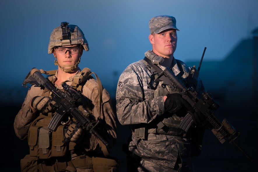 U.S. Air Force Senior Airman Shaun McQuiston and U.S. Marine Corps Lance Cpl. Michael Hall, both 407th Expeditionary Security Forces Squadron, pose for a photo at the 407th Air Expeditionary Group, Southwest Asia Dec. 17, 2016. The expeditionary security forces unit uses active duty and reserve Airmen and Marines as well as Polish forces working together to keep the base secure.  (U.S. Air Force photo/Master Sgt. Benjamin Wilson)(Released)