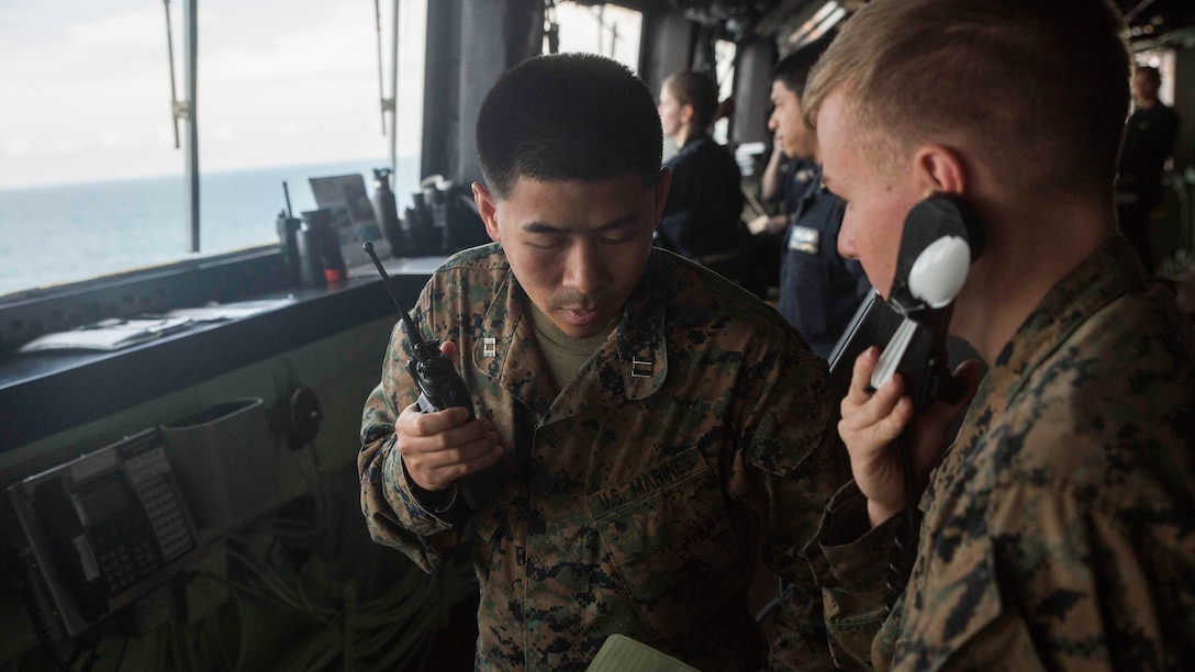 Capt. Huy Truong, the assistant operations officer for 3rd Battalion, 6th Marine Regiment, relays information from the joint fires observer to his Marines providing security on the decks of USS Mesa Verde (LPD 19) during a simulated straight transit to rehearse a defense of the amphibious task force mission during Amphibious Ready Group Marine Expeditionary Unit Exercise Dec. 13, 2016. During the three-week training evolution, Marines will tackle a wide range of operations and scenarios enhancing interoperability and amphibious warfare capabilities with their Navy counterparts. The additional firepower Marines provide improves the Navy-Marine Corps team’s ability to defend the naval vessels of the Bataan Amphibious Ready Group. 