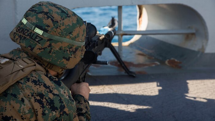 Lance Cpl. Ernesto Gonzalez, an artilleryman from 3rd Battalion, 6th Marine Regiment, with the 24th Marine Expeditionary Unit holds security aboard USS Mesa Verde (LPD 19), during a simulated straight transit to rehearse a defense of the amphibious task force mission during Amphibious Ready Group Marine Expeditionary Unit Exercise Dec. 13, 2016. During the three-week training evolution, Marines will tackle a wide range of operations and scenarios enhancing interoperability and amphibious warfare capabilities with their Navy counterparts. The additional firepower Marines provide improves the Navy-Marine Corps team’s ability to defend the naval vessels of the Bataan Amphibious Ready Group. 