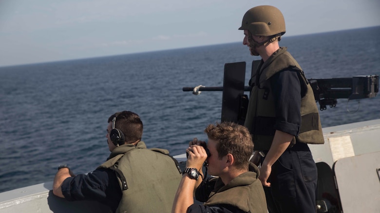 Sailors with the small caliber arms team observe and report any vessels they see from the forecastle aboard USS Mesa Verde (LPD 19), during a simulated straight transit to rehearse a defense of the amphibious task force mission during Amphibious Ready Group Marine Expeditionary Unit Exercise Dec. 13, 2016. During the three-week training evolution, Marines will tackle a wide range of operations and scenarios enhancing interoperability and amphibious warfare capabilities with their Navy counterparts. The additional firepower Marines provide improves the Navy-Marine Corps team’s ability to defend the naval vessels of the Bataan Amphibious Ready Group. 