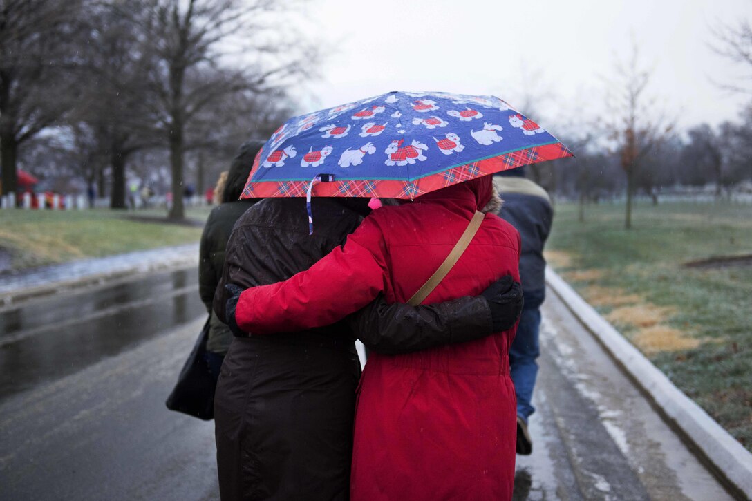 Volunteers brave the wet and cold weather to place wreaths at headstones at Arlington National Cemetery, Va., for Wreaths Across America, Dec. 17, 2016. Army photo by Rachel Larue