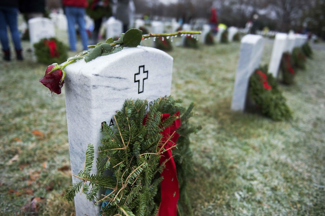 A rose rests on a headstone during Wreaths Across America at Arlington National Cemetery, Va., Dec. 17, 2016. Army photo by Rachel Larue