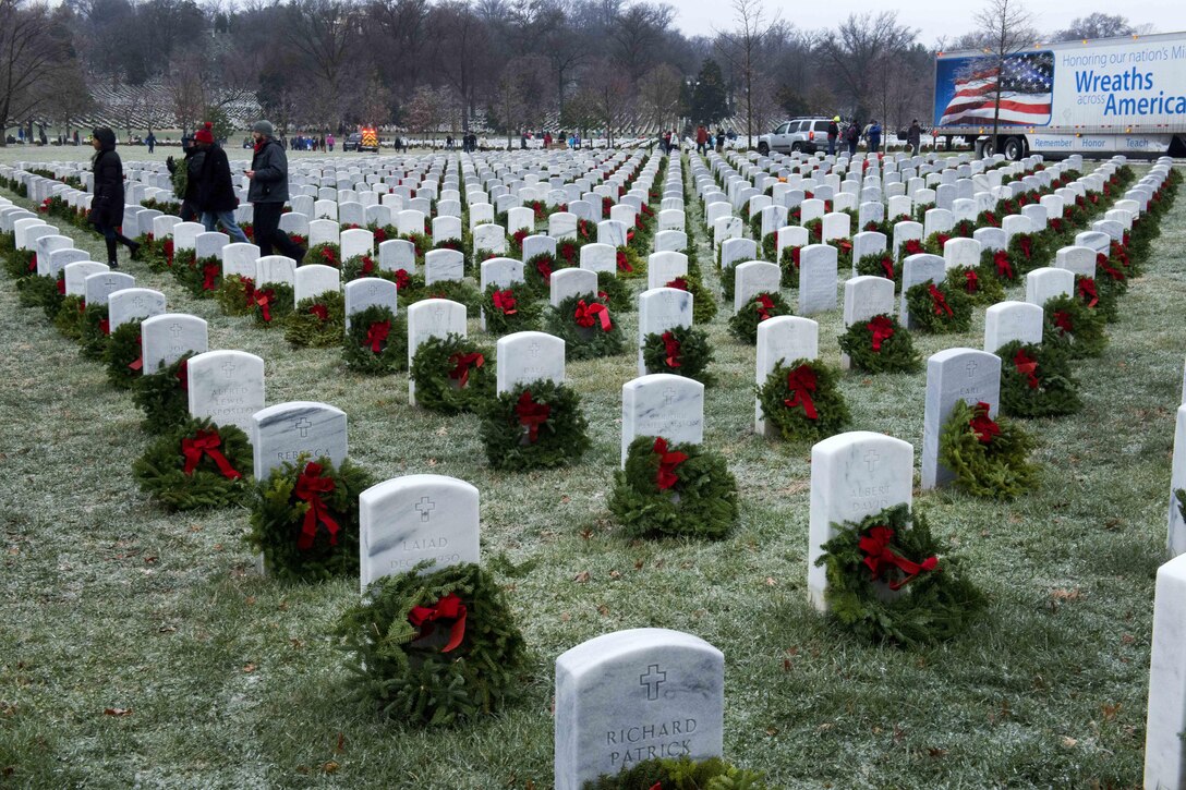 Volunteers carry wreaths to place at headstones during Wreaths Across America at Arlington National Cemetery, Va., Dec. 17, 2016. Army photo by Rachel Larue
