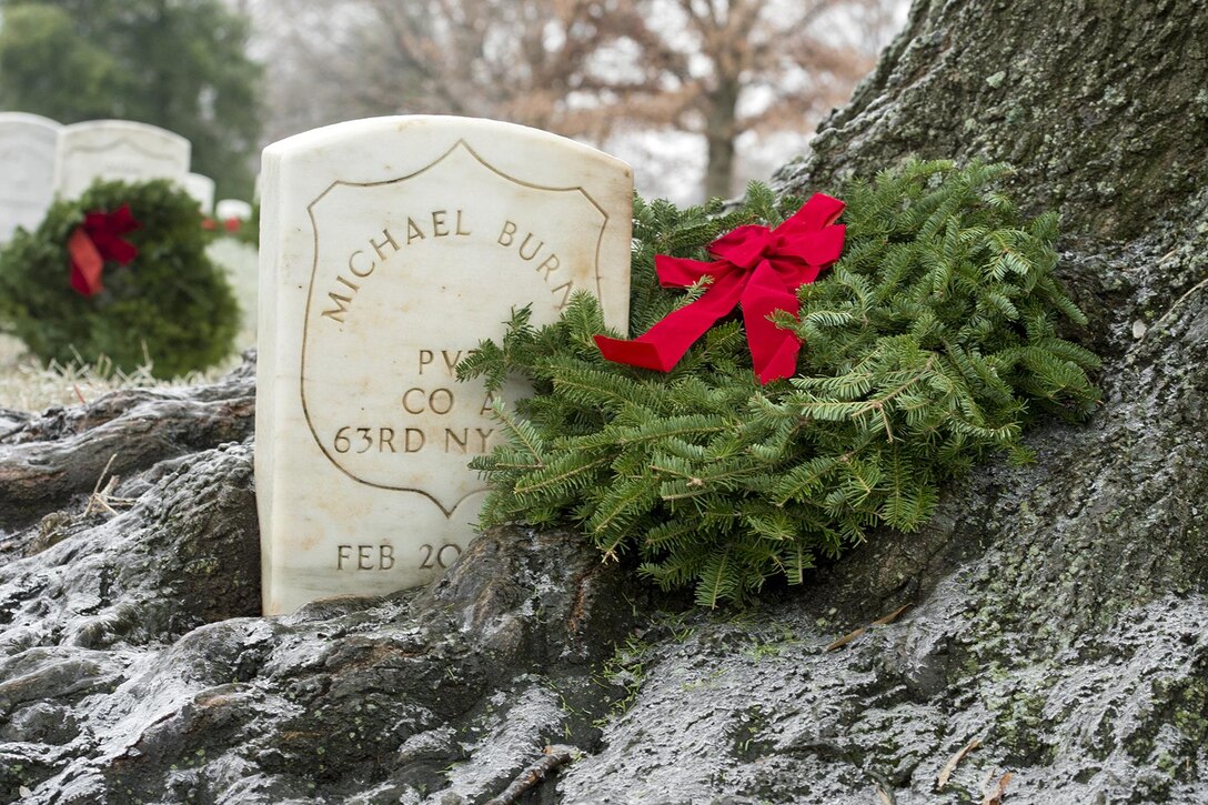 A wreath placed during Wreaths Across America adorns a headstone at Arlington National Cemetery, Va., Dec. 17, 2016. DoD photo by EJ Hersom