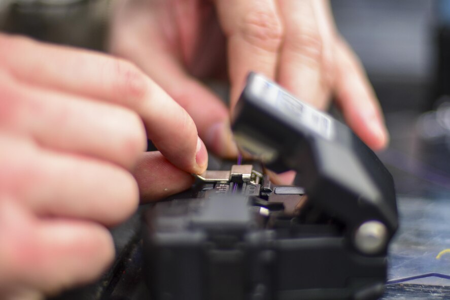 U.S. Air Force Staff Sgt. Adam Nichols, 51st Communications Squadron cable and antenna technician, cuts a wire down to size during a joint communications exercise at Gwanju Air Base, Republic of Korea, Dec. 13, 2016. Nichols and several other 51st CS Airmen worked alongside their ROK air force counterparts to restore network and telephone functionality in a simulated wartime environment during the exercise. (U.S. Air Force photo by Senior Airman Victor J. Caputo)