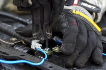 U.S. Air Force Staff Sgt. Adam Nichols, 51st Communications Squadron cable and antenna technician, prepares to secure a wire during a joint communications exercise at Gwanju Air Base, Republic of Korea, Dec. 13, 2016. Nichols and several other 51st CS Airmen worked alongside their ROK air force counterparts to restore network and telephone functionality in a simulated wartime environment during the exercise. (U.S. Air Force photo by Senior Airman Victor J. Caputo)